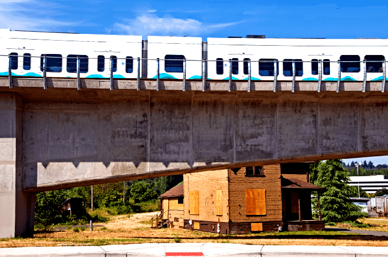 Light rail train passing over street